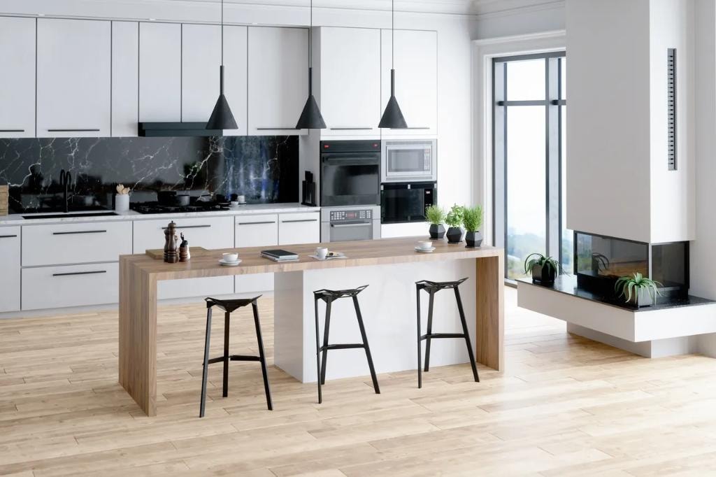 Minimalist white kitchen with black marble backsplash and wood island